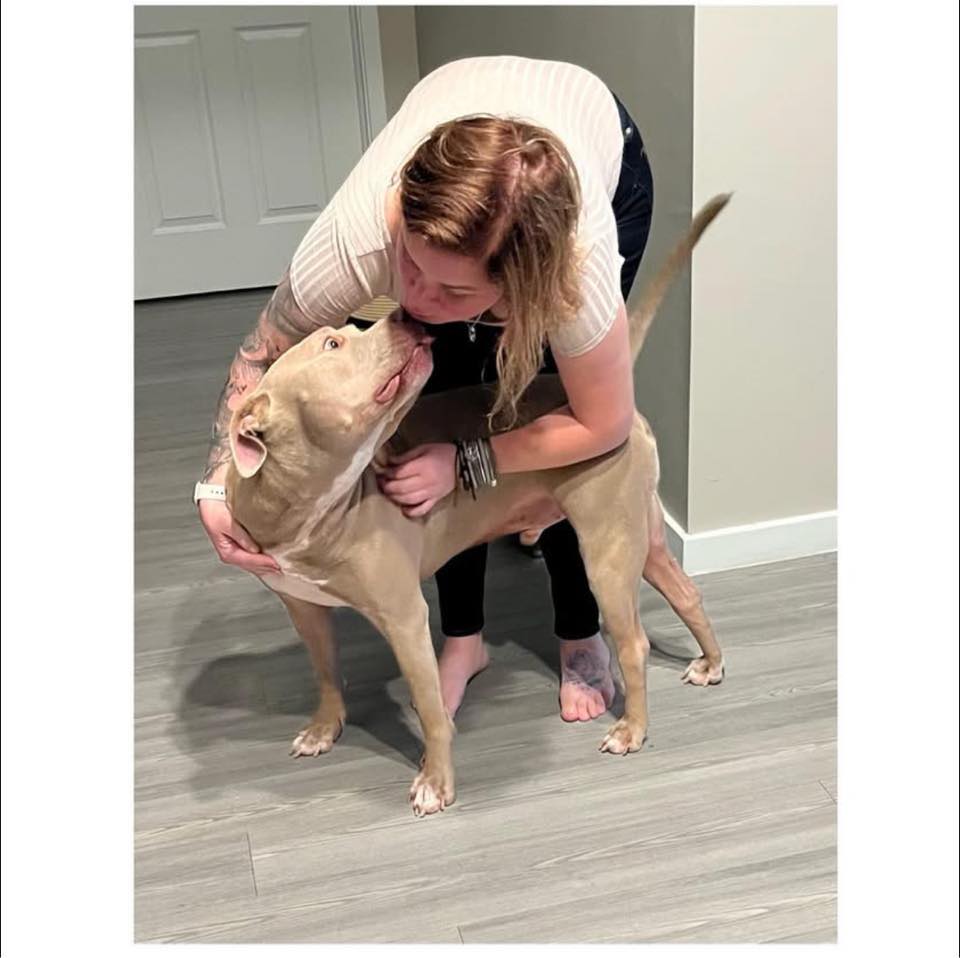 woman hugging dog